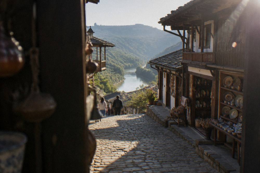 Cobbled old street with traditional houses above a river gorge in a Bulgarian town
