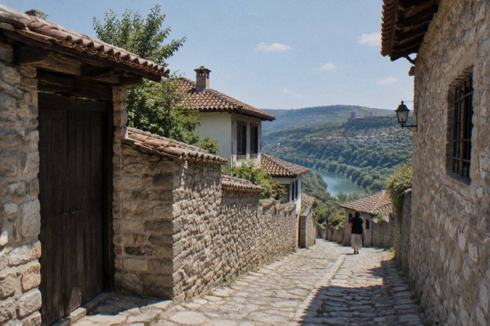 Fortified stone houses with high walls and wooden gates on a village lane