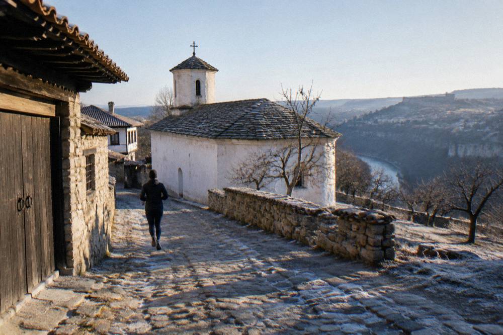 The whitewashed exterior of a medieval Bulgarian church with a stone roof