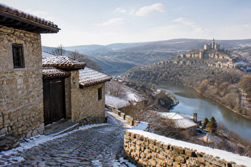 A panoramic view from a plateau edge over a river bend and a hilltop fortress