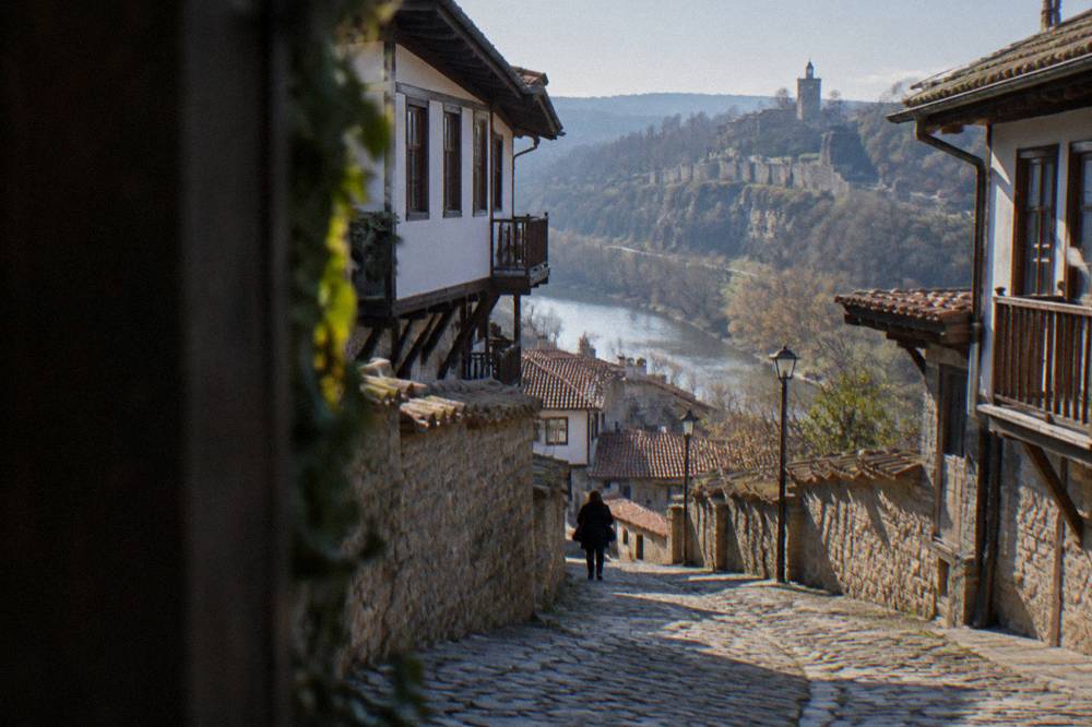 A stone street in the old town of Veliko Tarnovo with historic houses on either side