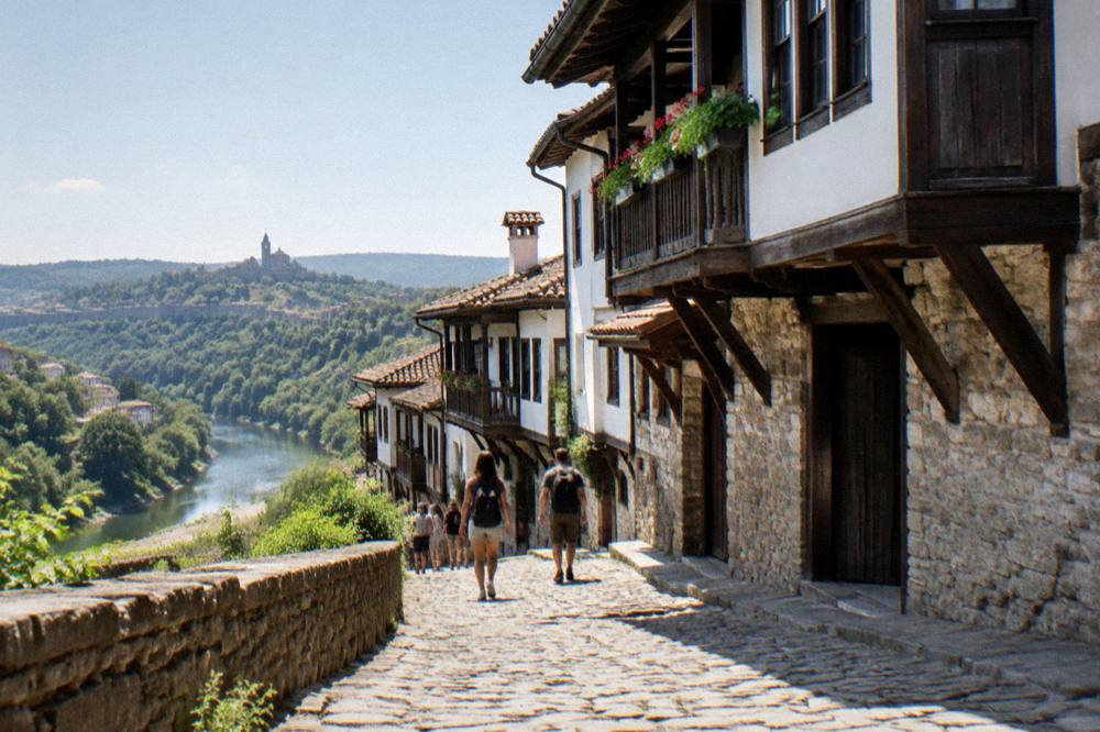 Visitors walking a cobbled street between old houses in Veliko Tarnovo