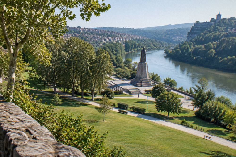 The Asenevtsi Monument on its pedestal beside the Yantra river below the old city