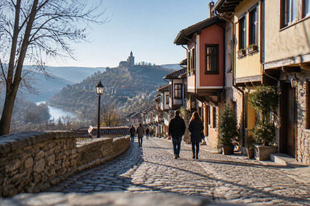 People strolling on a cobbled street in an old Bulgarian quarter on a sunny afternoon