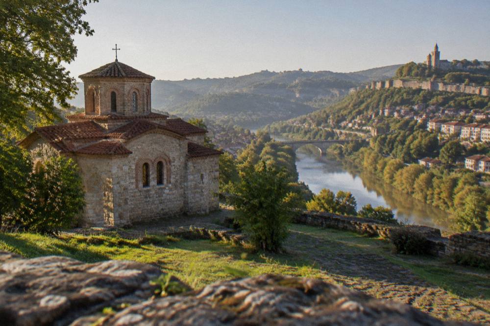 Panoramic view of a hillside city with church towers and a river loop below