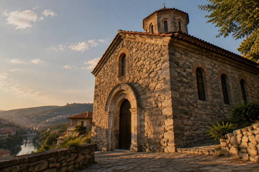 Facade of a medieval stone church with arched doorway in daylight