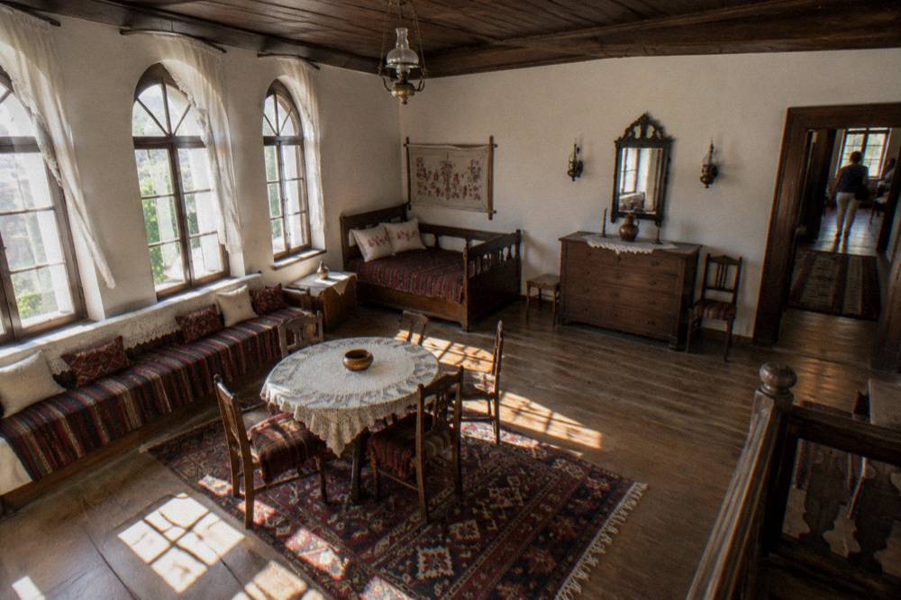 A restored nineteenth-century Bulgarian house interior with wooden ceilings and period furniture