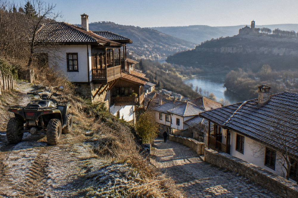 An ATV parked on a dirt track above the rooftops and river bends of Veliko Tarnovo