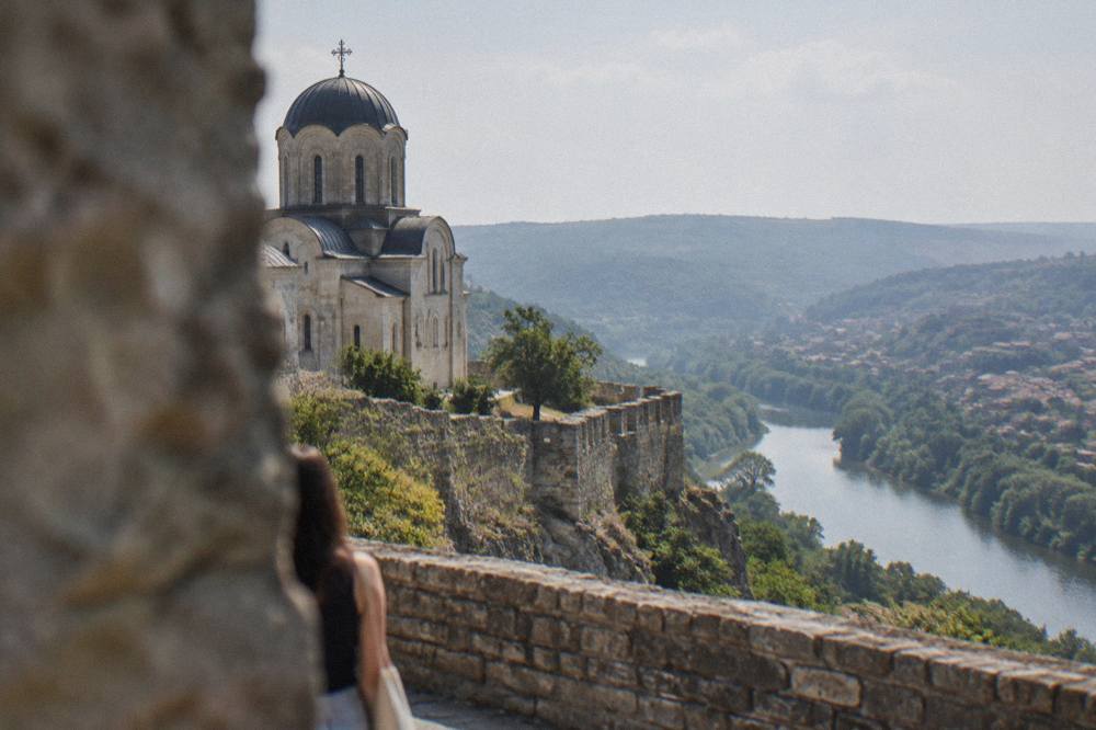 Stone walls of the Patriarchal Cathedral on Tsarevets with the Yantra river valley behind