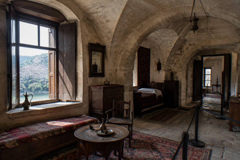 The vaulted stone interior of a museum house in Veliko Tarnovo with period furnishings