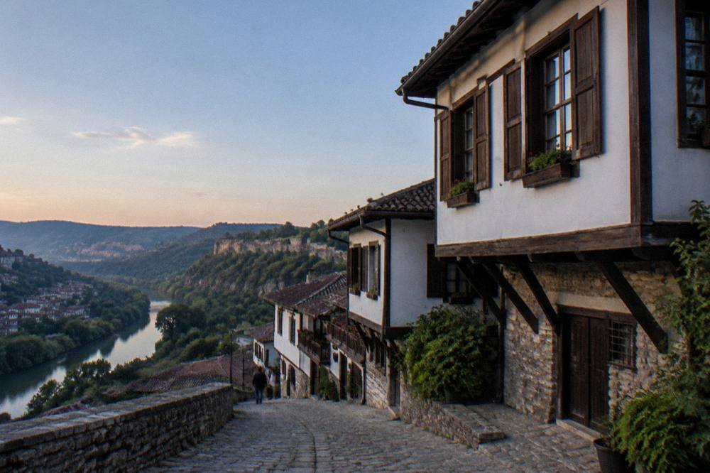 A traditional Bulgarian Revival house facade with white walls and wooden shutters in Veliko Tarnovo