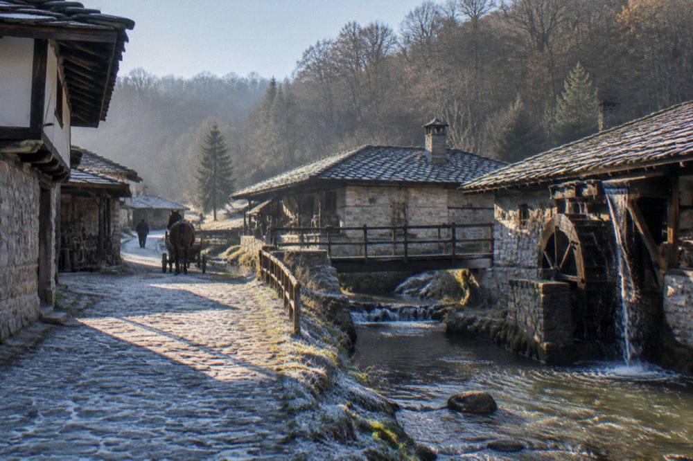 A horse-drawn mill and workshops of an open-air museum beside a mountain stream