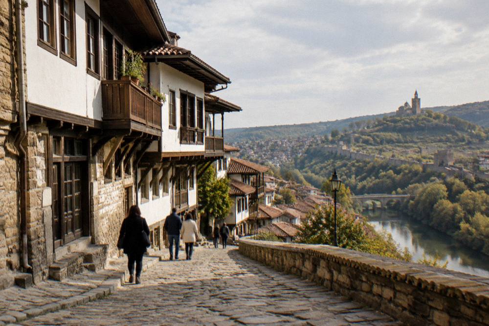 Visitors walking a cobbled street in the old town of Veliko Tarnovo in warm afternoon light