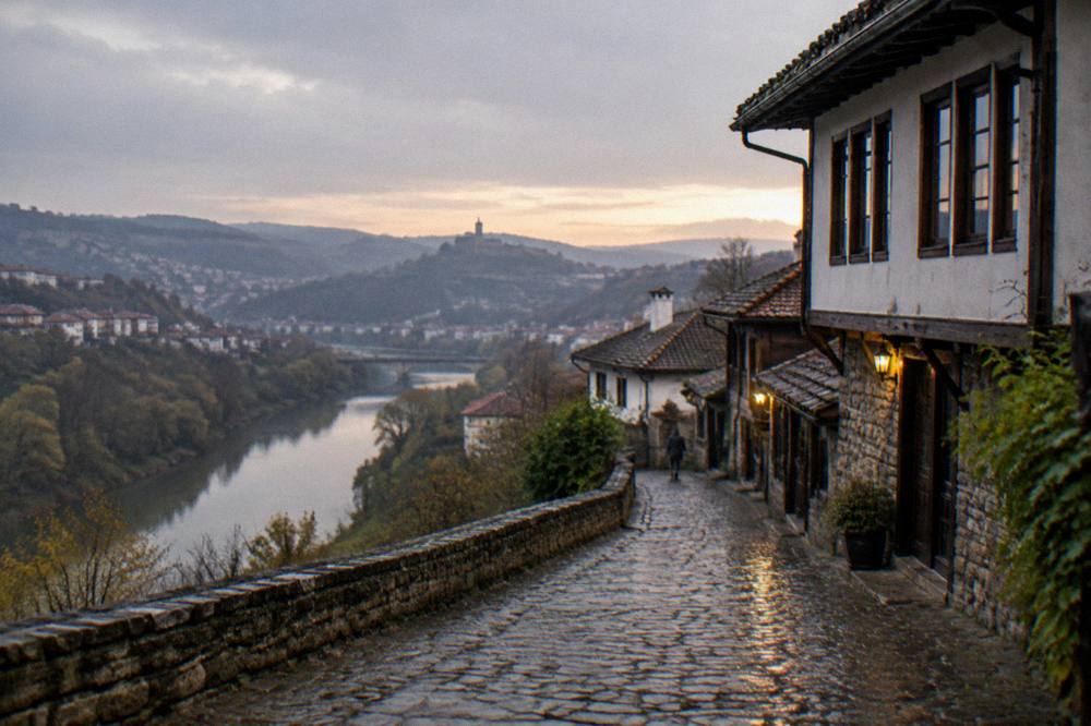 Cobbled old street with revival-era houses above a river gorge at dusk