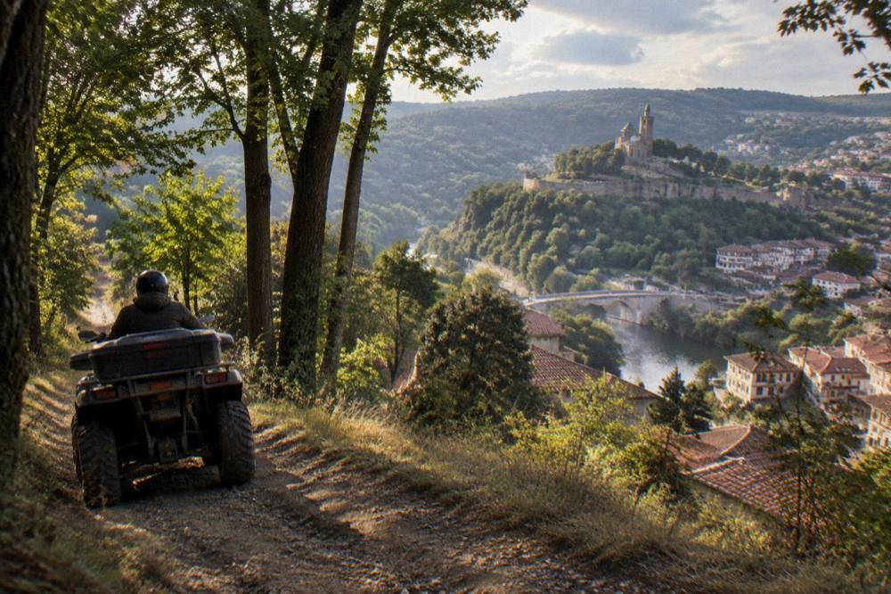 An all-terrain vehicle on a dirt track above a valley with a distant monastery