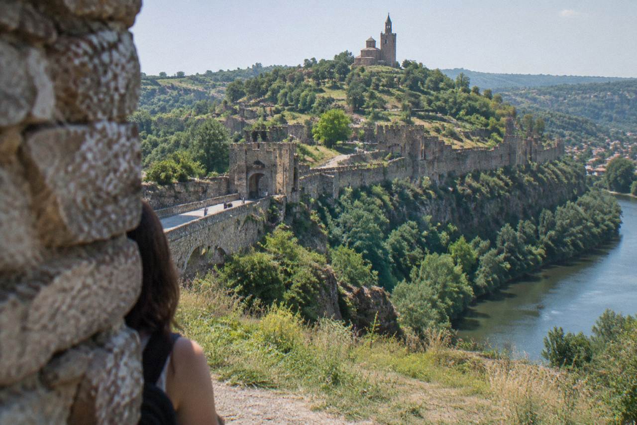 Stone walls and towers of a hilltop medieval fortress in morning light