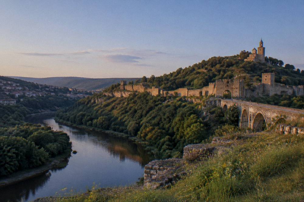 The Yantra river curving below the Tsarevets fortress hill in warm evening light