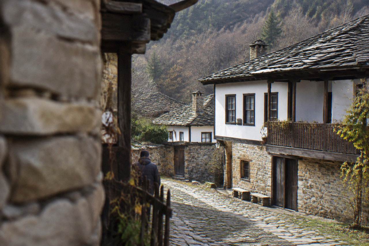 Stone-roofed Revival houses along the single street of Bozhentsi village