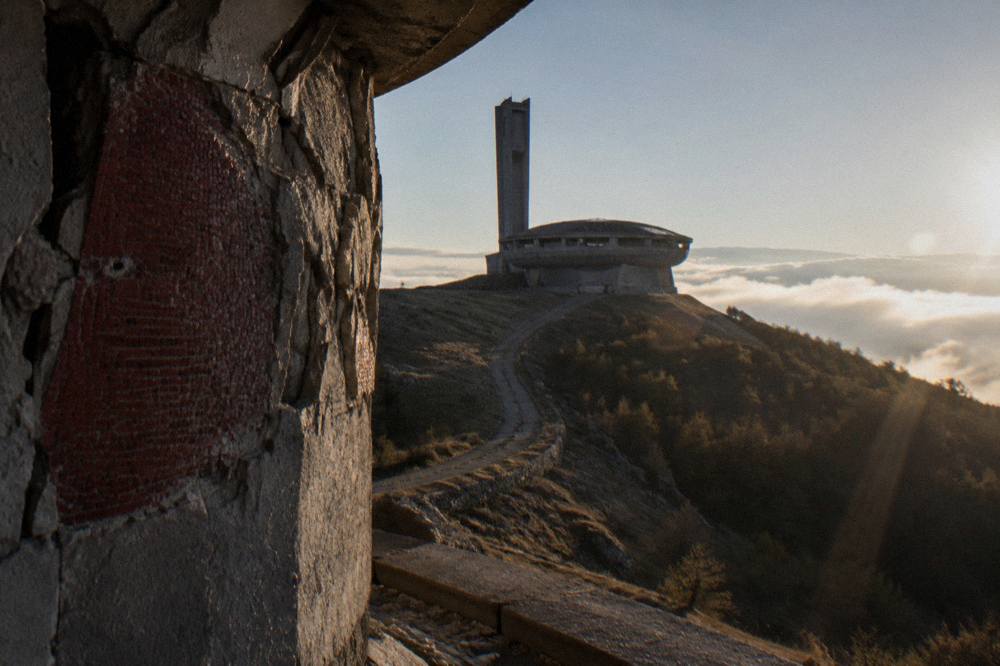 Close view of weathered concrete walls with a red mosaic fragment on the Buzludzha peak