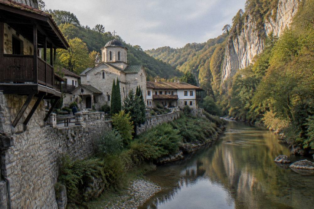 A river flowing between limestone cliffs in a green gorge at golden hour