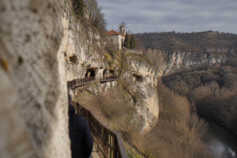 Small village church and limestone cliffs at the edge of a rural settlement