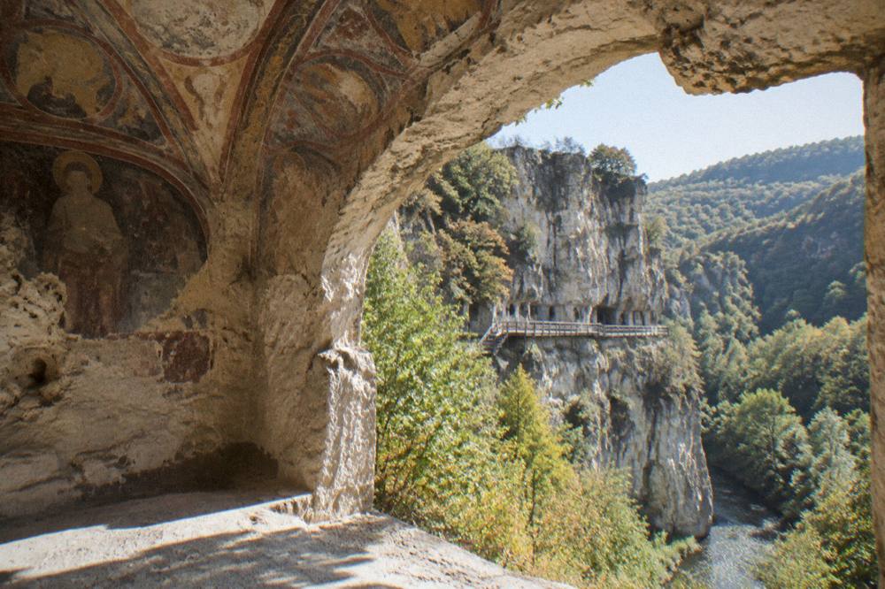 Frescoed vaulted ceiling inside a cave chapel carved from limestone