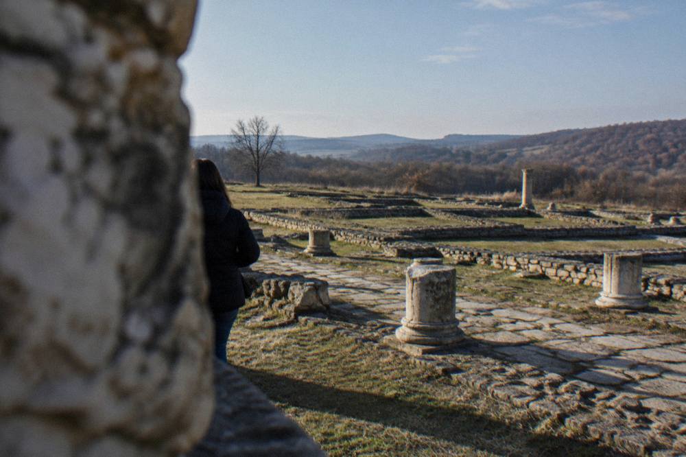 Grid of ancient stone foundation walls crossing a grassy field