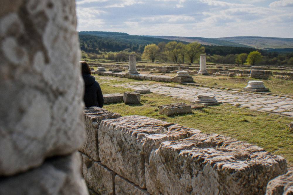 Close view of cut limestone blocks forming a low ancient wall