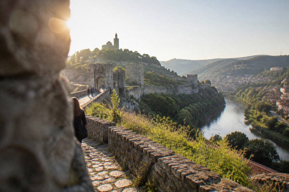 Stone fortress walls and a hilltop path at Tsarevets in morning light