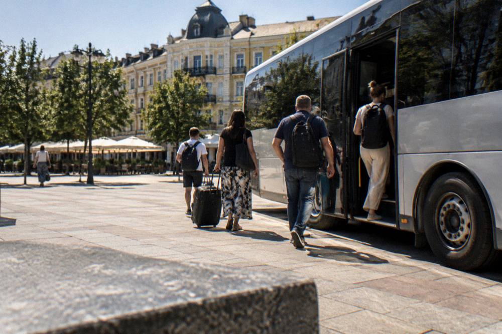 Passengers boarding a modern intercity bus at a city terminal in Bulgaria