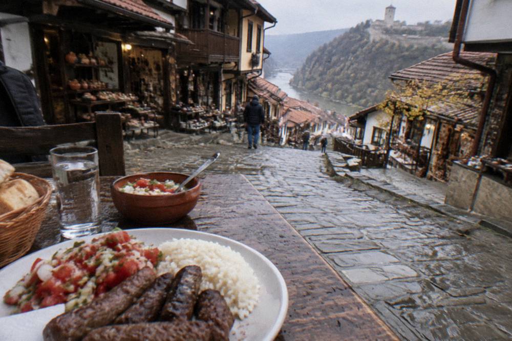 Grilled kebapche and kyufte served with rice and a salad on a rustic table