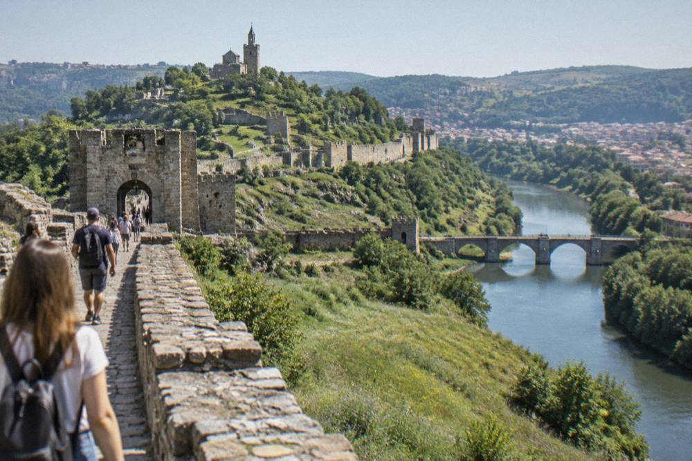 Visitors walking the fortress walls of Tsarevets above the Yantra river