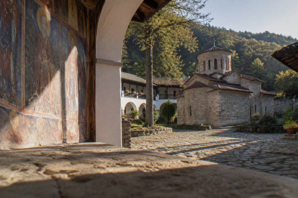 Frescoed interior wall of a medieval Bulgarian church lit by natural light