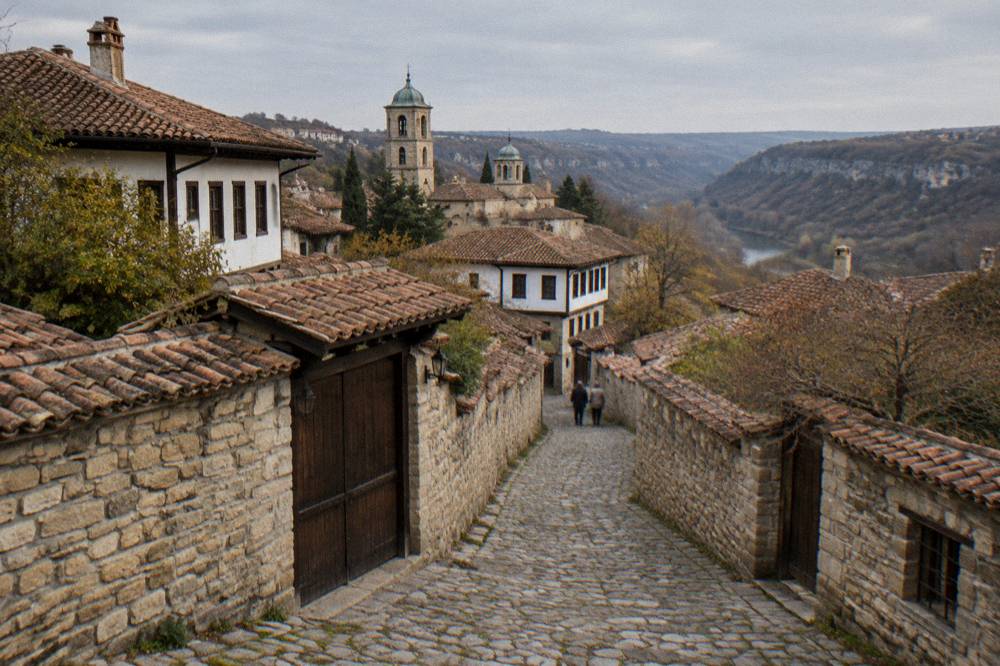 Cobbled village lane with stone walls and church towers in Arbanasi