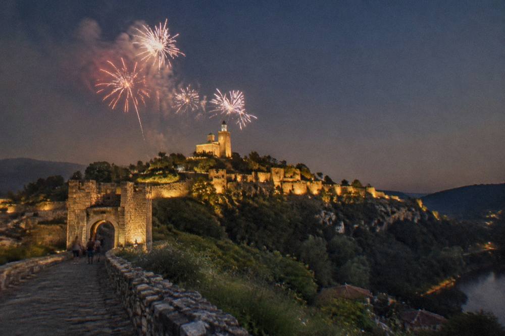 Fireworks over the illuminated fortress walls of Veliko Tarnovo at night