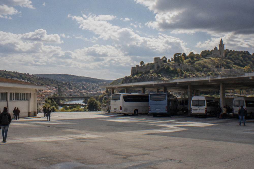 Buses parked at a small city bus station in a Bulgarian town