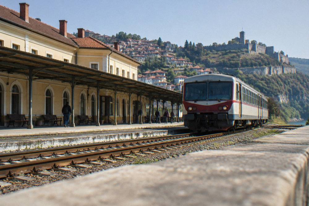 Regional train waiting at a small Bulgarian railway station platform