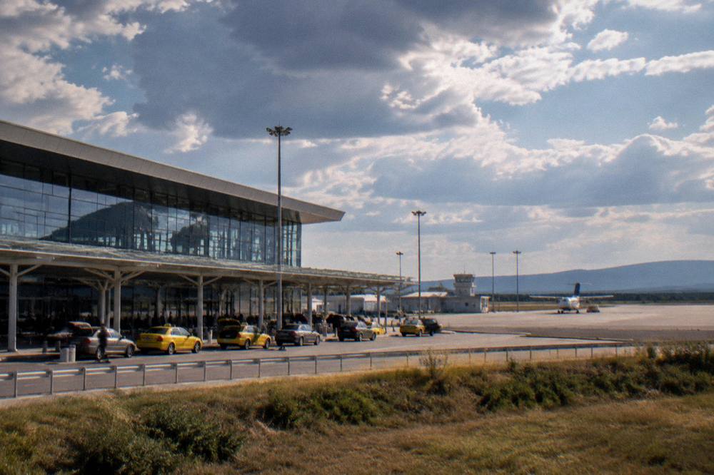 Small regional airfield with a single runway and low buildings under a wide sky