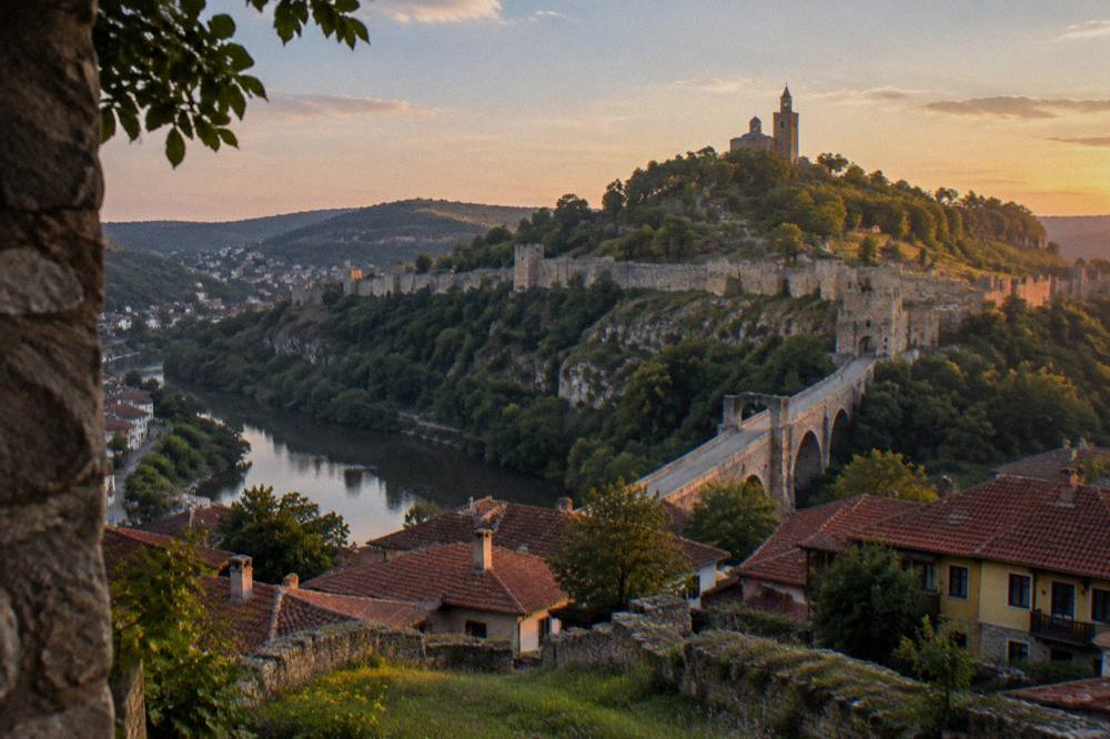 Evening view of Tsarevets Fortress hill illuminated above the rooftops of Veliko Tarnovo
