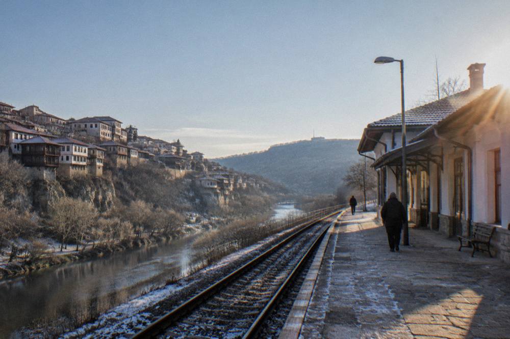 A railway platform beside a small station building on a cold morning