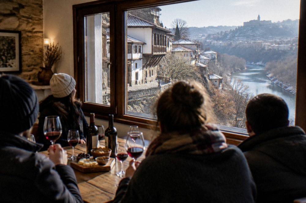 A group of visitors at a tasting table with glasses of red wine in a warm room