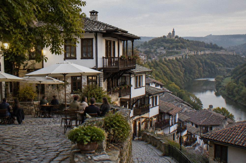 People seated at outdoor tables on a small square in the evening