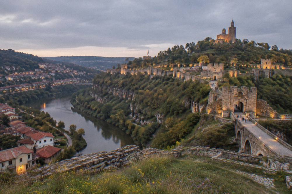 Evening lights on the hillside houses and fortress walls of the old capital