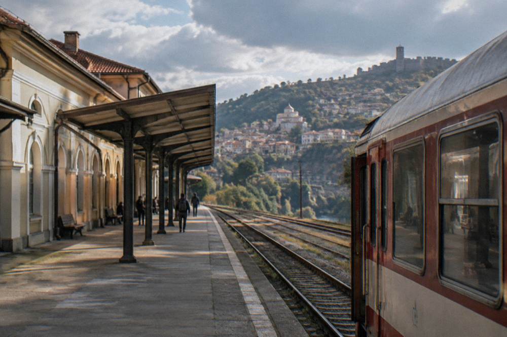 A train waiting at a small Balkan railway station platform