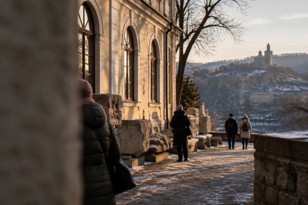 Visitors looking at medieval stone exhibits inside the Archaeological Museum in Veliko Tarnovo