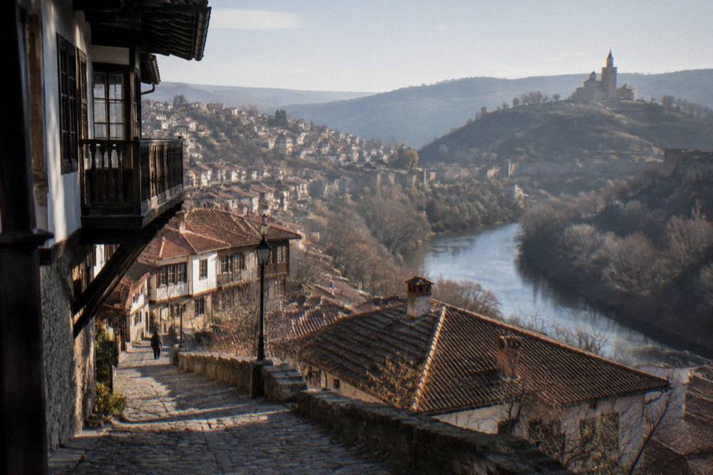 Panoramic view over red rooftops of Veliko Tarnovo from a hillside terrace